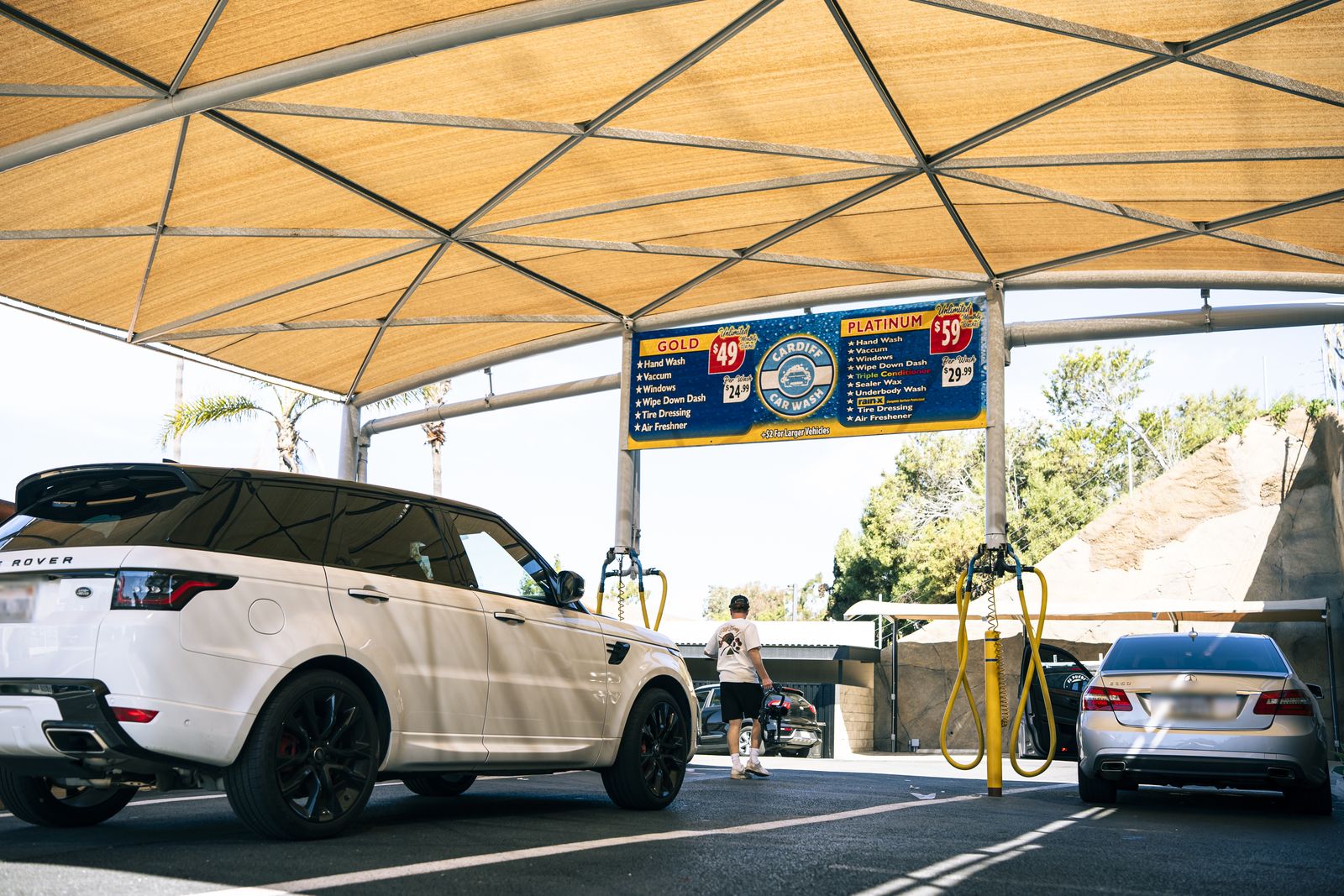 A white Range Rover Sport under the shade canopy
