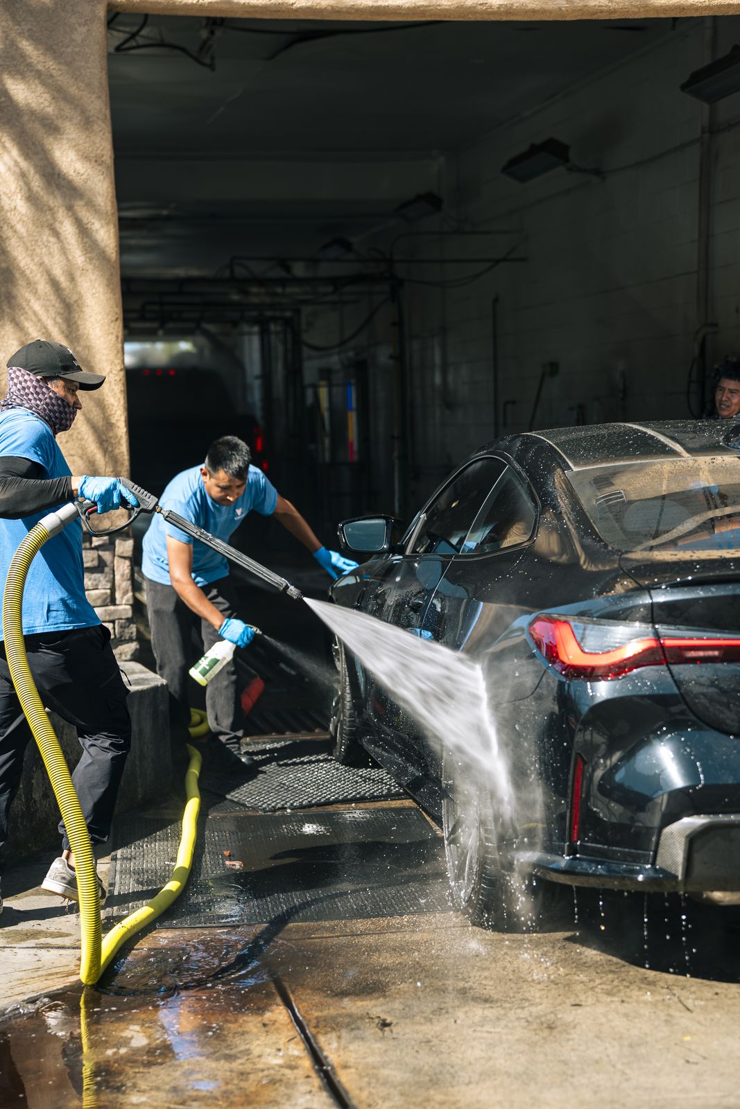 A car being hand-washed on the bay track at Cardiff Car Wash